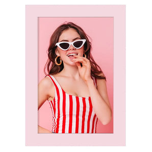 Custom pink photo frame with playful woman in striped top and sunglasses, stylish wall art