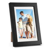 Black photo frame displaying a family beach picture, customizable home decor