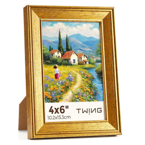 Gold 4x6 picture frame with countryside artwork, standing on a white background