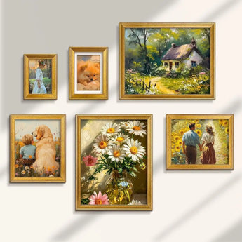 Gallery wall with gold frames featuring floral art, cottage landscape, people, and pets