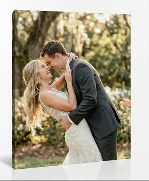 Custom canvas print of newlywed couple embracing outdoors in wedding attire