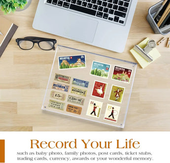 Custom acrylic frame displaying vintage stamps and tickets on a modern desk with laptop and glasses.