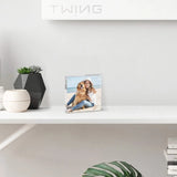 Custom acrylic photo frame with woman and dog on beach, displayed on modern shelf with decor