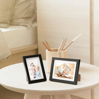 Personalized photo frames with family pictures on a round bedside table, cozy decor style