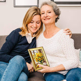 Two women on a sofa holding a custom sunflower photo frame for home decor