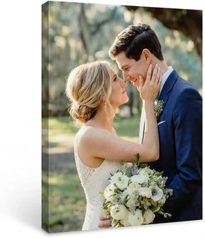 Custom canvas print featuring a bride and groom embracing outdoors with bouquet