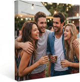 Custom canvas print featuring friends laughing together at an outdoor party with string lights