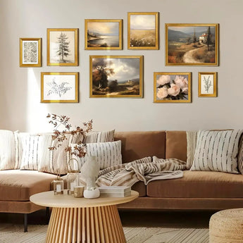 Living room with custom gold-framed art and botanical wall prints above a beige sofa.