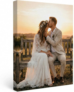 Custom canvas print of newlyweds sitting on a bench at sunset, romantic wedding decor