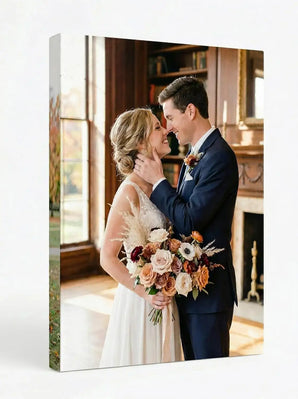Custom canvas print of a bride and groom embracing with wedding bouquet indoors