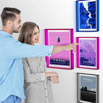 Couple admiring colorful custom framed artwork and canvas prints on a modern home wall