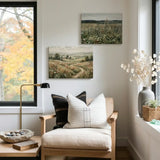 Modern living room with custom landscape canvas prints, neutral decor, and cozy armchair