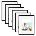 Set of five black photo frames displaying a beach picnic scene, customizable home decor